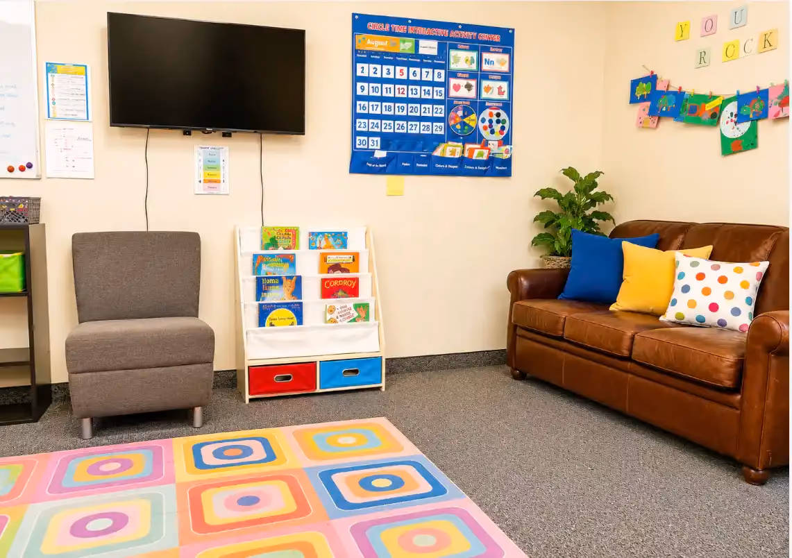 Therapy play zone at the Laramie clinic with sensory toys, a small table, and bright natural light.